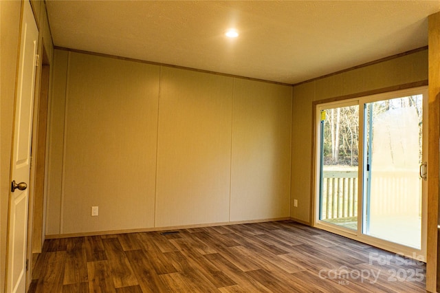 unfurnished room featuring wood-type flooring and crown molding