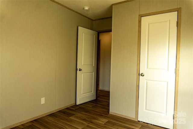 unfurnished bedroom featuring dark hardwood / wood-style flooring