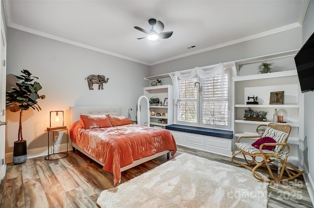 bedroom with hardwood / wood-style flooring, ceiling fan, and ornamental molding