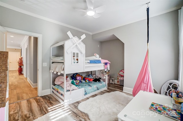 bedroom featuring crown molding, ceiling fan, and hardwood / wood-style floors