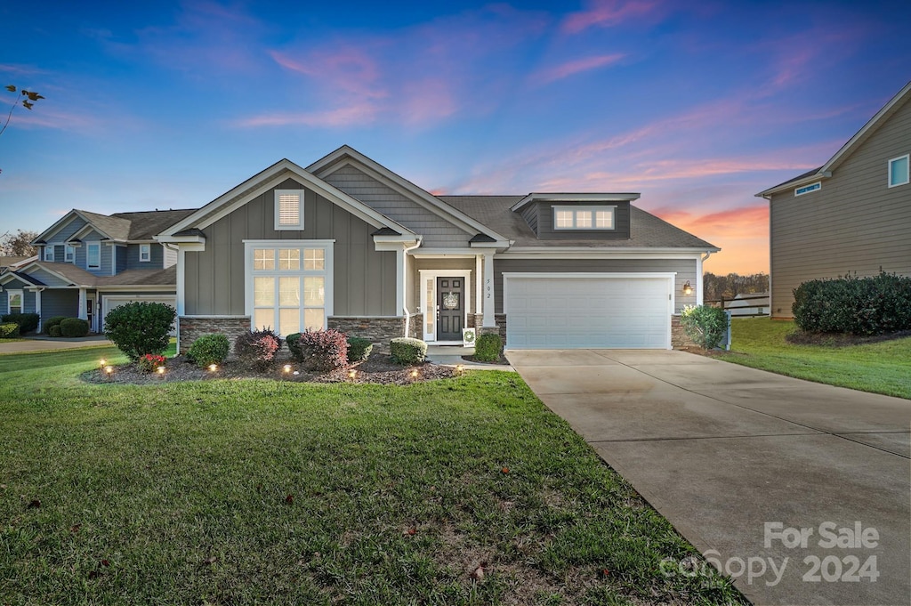 craftsman-style home with a yard and a garage