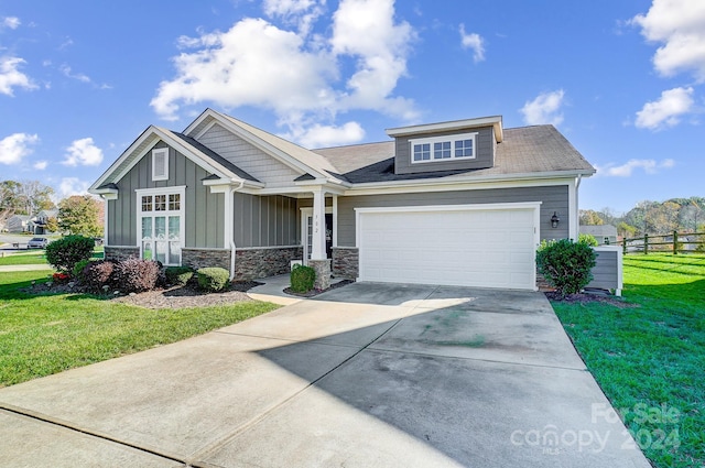 craftsman-style house featuring a garage and a front lawn