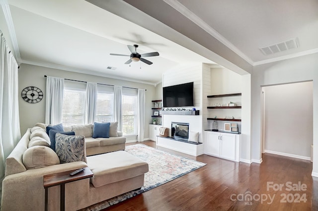 living room featuring ornamental molding, ceiling fan, dark wood-type flooring, a fireplace, and lofted ceiling