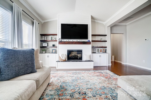 living room with a fireplace, dark hardwood / wood-style floors, vaulted ceiling, and crown molding