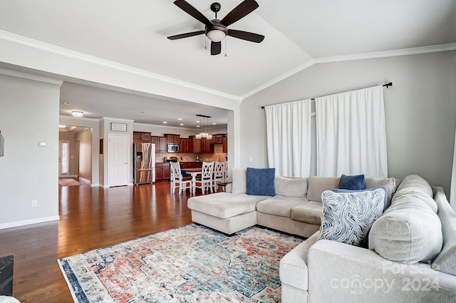 living room with ceiling fan, dark wood-type flooring, crown molding, plenty of natural light, and vaulted ceiling