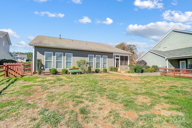 rear view of house featuring a yard