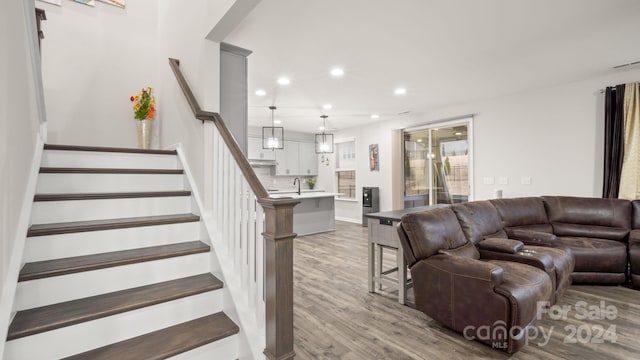 living room featuring light hardwood / wood-style floors and sink