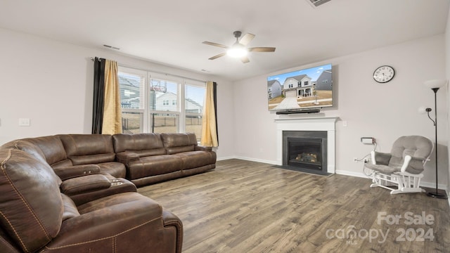 living room with wood-type flooring and ceiling fan