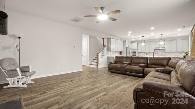 living room featuring ceiling fan and hardwood / wood-style floors