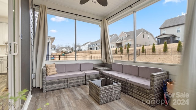 sunroom featuring ceiling fan and a healthy amount of sunlight