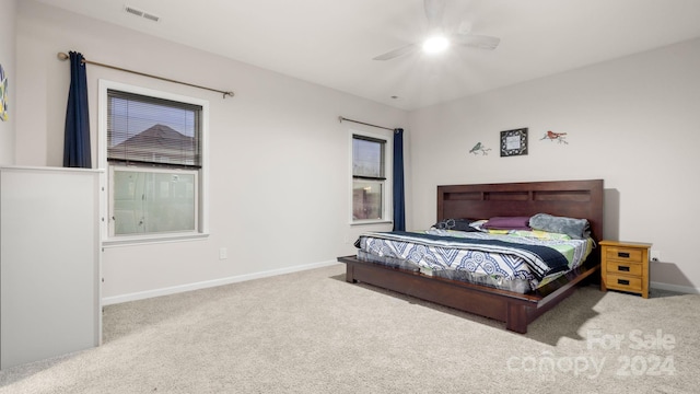 bedroom featuring light colored carpet and ceiling fan