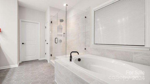 bathroom with tile patterned flooring and independent shower and bath