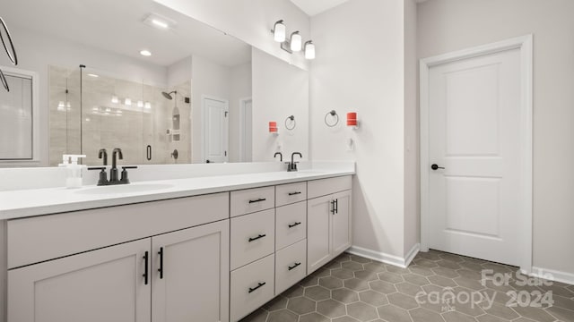 bathroom featuring tile patterned flooring, vanity, and a shower with shower door