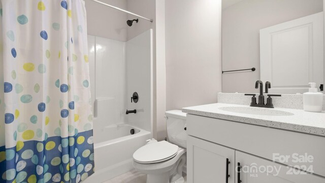 full bathroom with vanity, shower / bath combo, and toilet