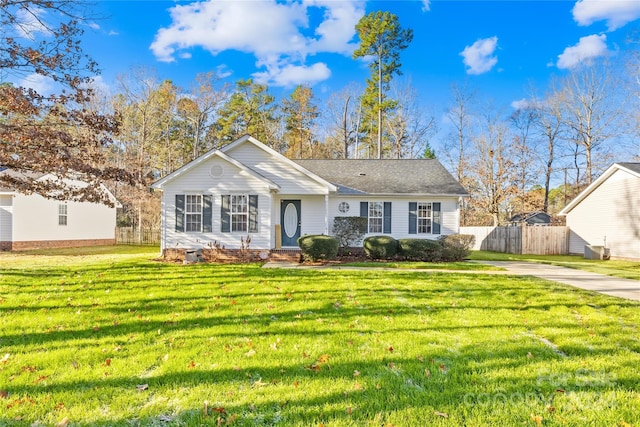 ranch-style home with cooling unit and a front yard