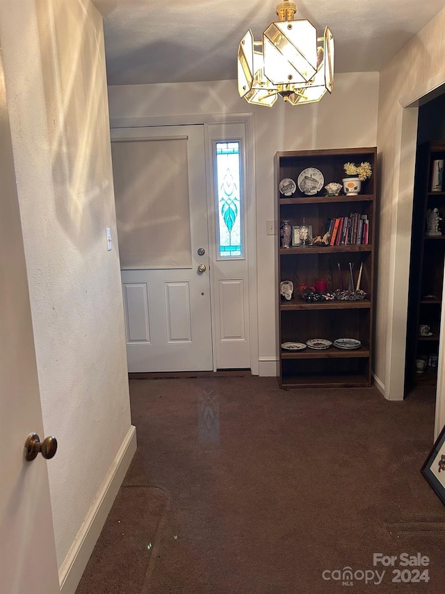 entryway with dark carpet