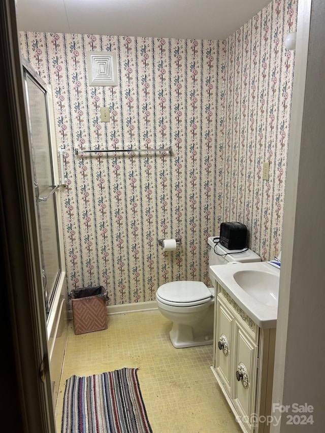 bathroom featuring tile patterned flooring, vanity, and toilet