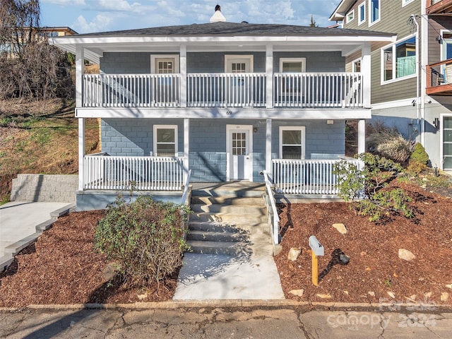 view of front of property with a porch and a balcony