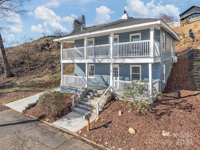 view of front facade featuring covered porch and a balcony