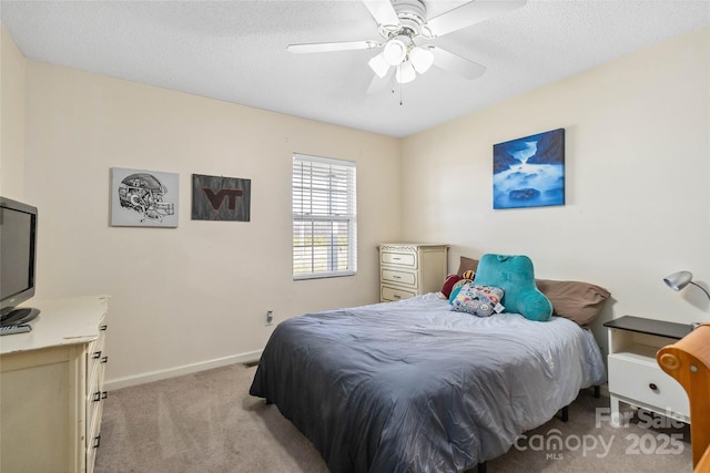 bedroom with light carpet, baseboards, ceiling fan, and a textured ceiling