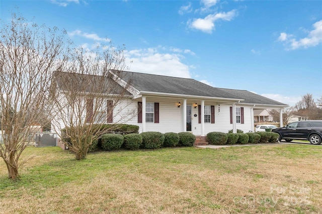 ranch-style home featuring a porch, a front yard, and central AC unit