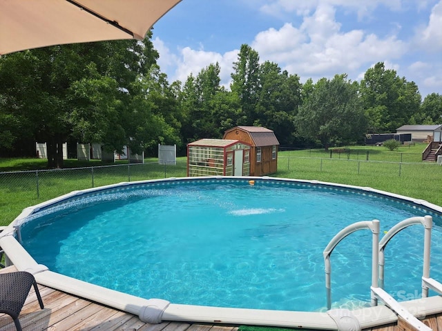 view of pool featuring a storage unit and an outdoor structure