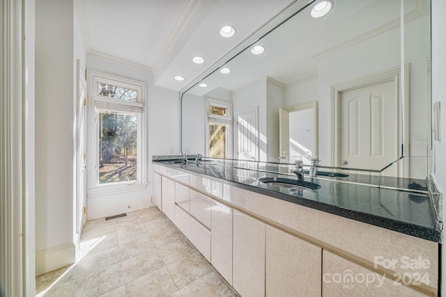 bathroom with crown molding, tile patterned flooring, and vanity