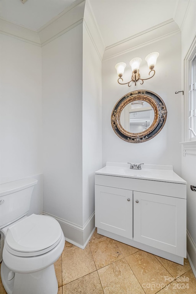 bathroom with tile patterned floors, vanity, toilet, and crown molding