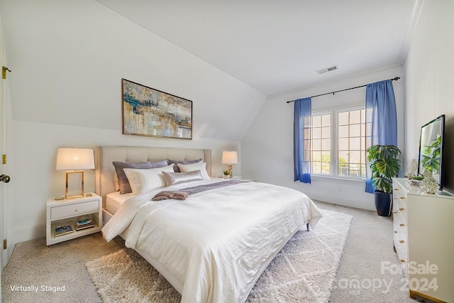 carpeted bedroom with vaulted ceiling and crown molding