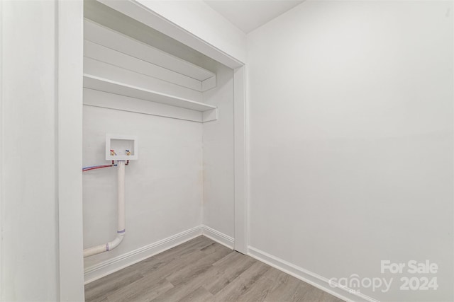 laundry room with washer hookup and wood-type flooring