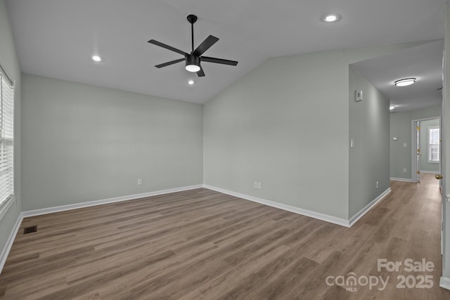 spare room with ceiling fan, lofted ceiling, and hardwood / wood-style flooring