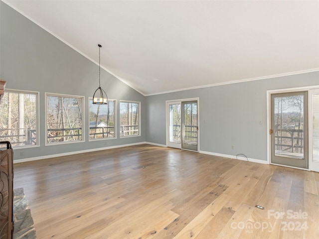 unfurnished living room featuring crown molding, light hardwood / wood-style flooring, high vaulted ceiling, and a notable chandelier