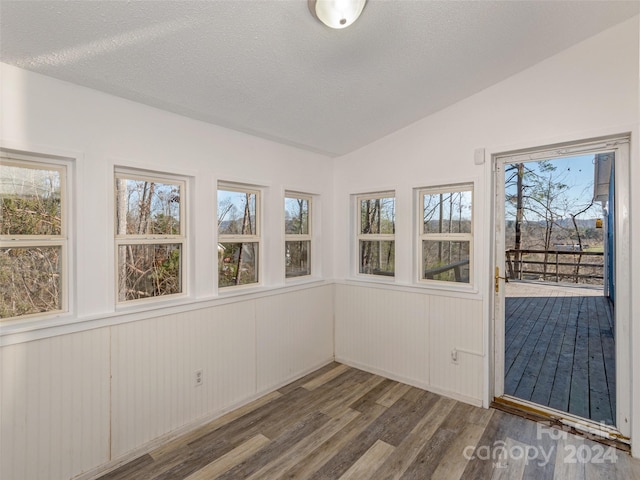 unfurnished sunroom with vaulted ceiling and a healthy amount of sunlight