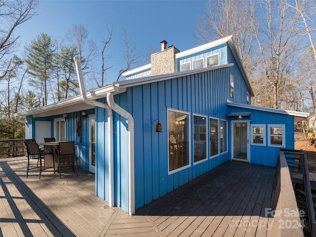 back of property featuring a wooden deck