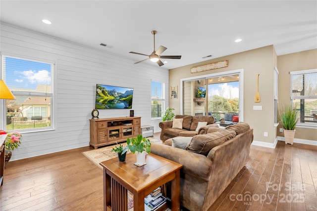 living room featuring hardwood / wood-style flooring and ceiling fan