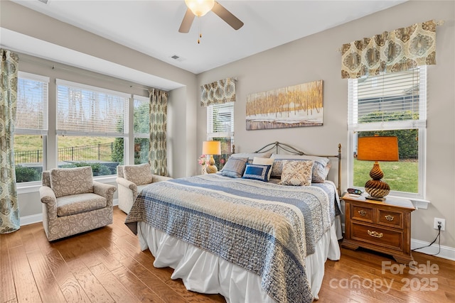 bedroom with wood-type flooring and ceiling fan