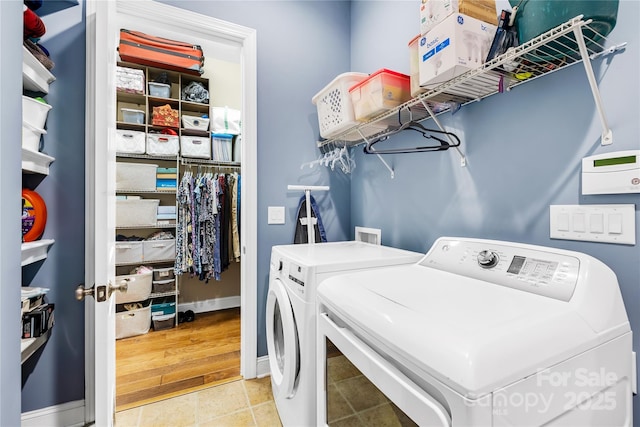 washroom featuring separate washer and dryer and light tile patterned floors