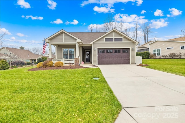 view of front of home with driveway, an attached garage, and a front yard