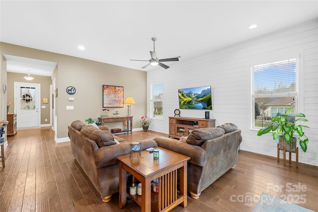 living room with ceiling fan, hardwood / wood-style floors, and a wealth of natural light