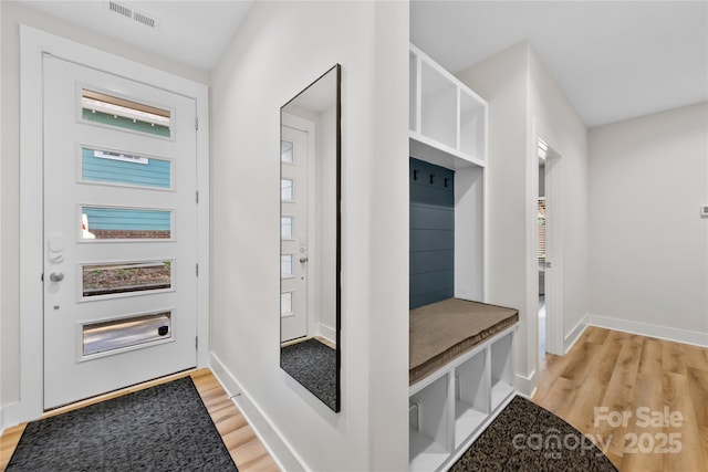 mudroom with light hardwood / wood-style floors