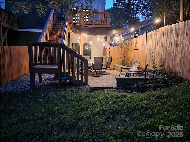 view of yard featuring stairway, a patio area, and a fenced backyard