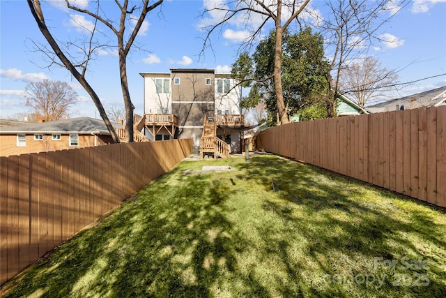 view of yard featuring stairs and a fenced backyard