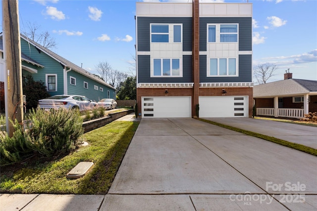 327 Coxe Ave, Charlotte, NC 28208 - view of front of property with an attached garage, concrete driveway, a standing seam roof, and metal roof