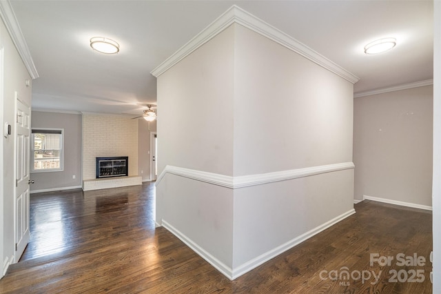 corridor featuring dark wood-type flooring and ornamental molding