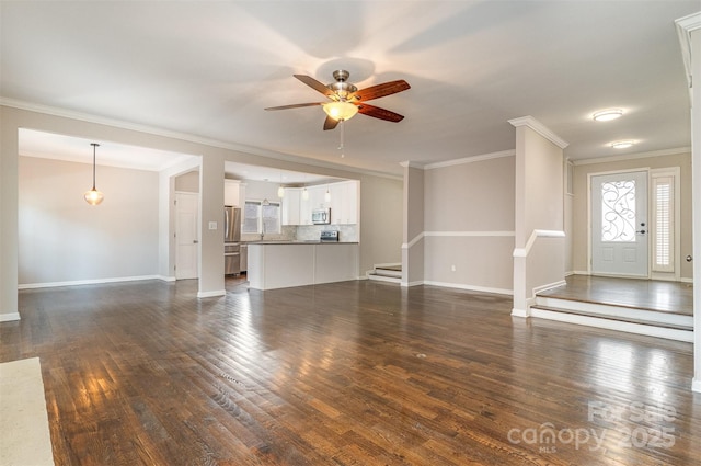 unfurnished living room featuring crown molding, ceiling fan, and dark wood-type flooring