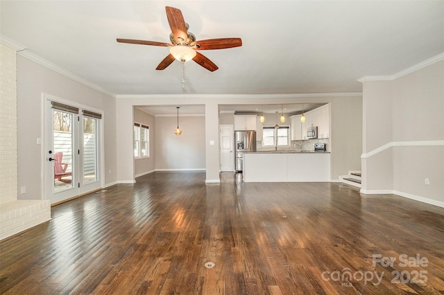 unfurnished living room with crown molding, ceiling fan, and dark wood-type flooring