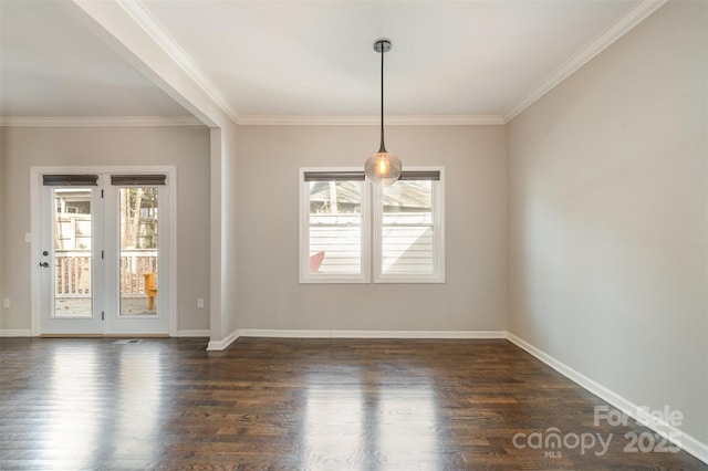 unfurnished dining area featuring dark hardwood / wood-style floors, ornamental molding, and a wealth of natural light