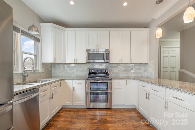 kitchen with white cabinets, pendant lighting, stainless steel appliances, and sink