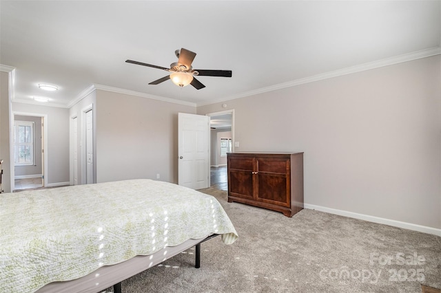 carpeted bedroom featuring a closet, ceiling fan, and ornamental molding