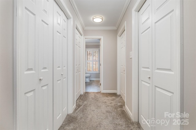 corridor with light colored carpet and crown molding